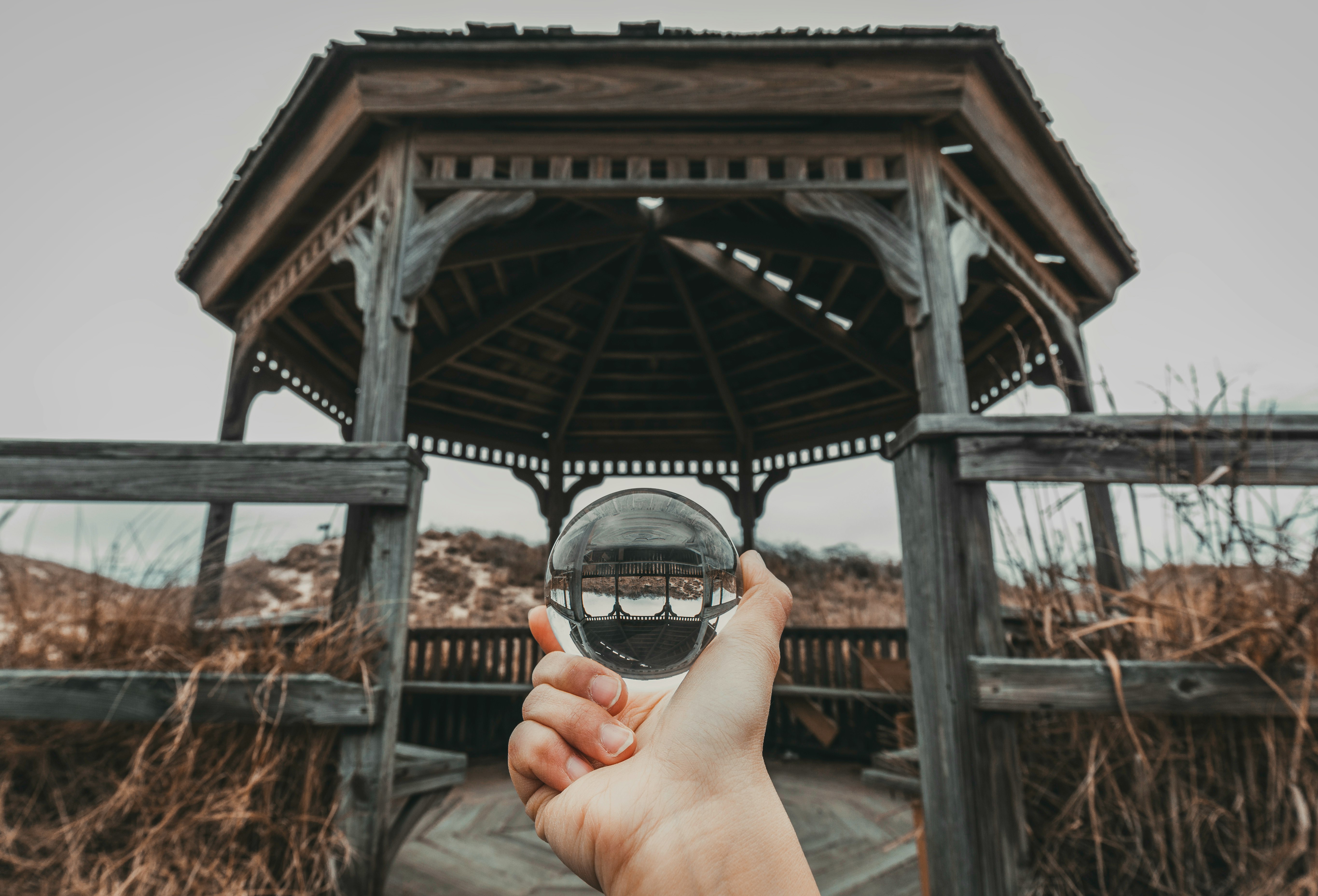 person holding ball in front of gazebo